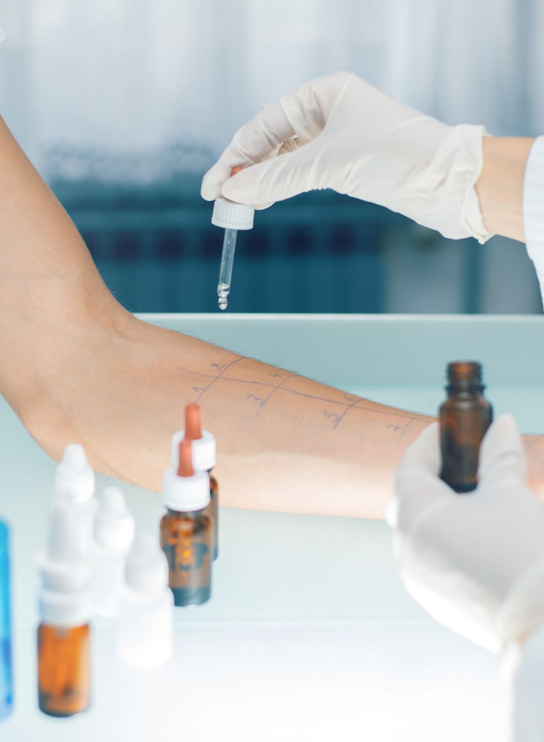 Woman in a floral dress among sunflowers.