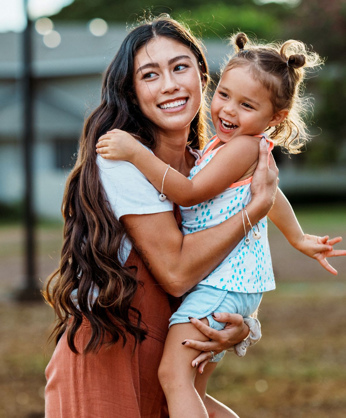 Mother and child sharing a joyful moment outdoors.