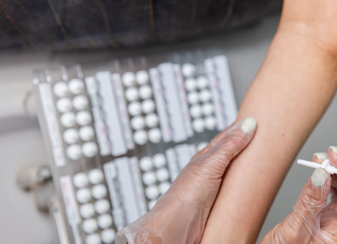 Administering medication on a patient's arm.